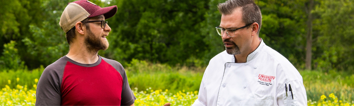 A photo of Mike Smith, the GCUOF Farm Coordinator and Andrew, our Executive Sous-Chef standing in a field of buckwheat and mustard talking.